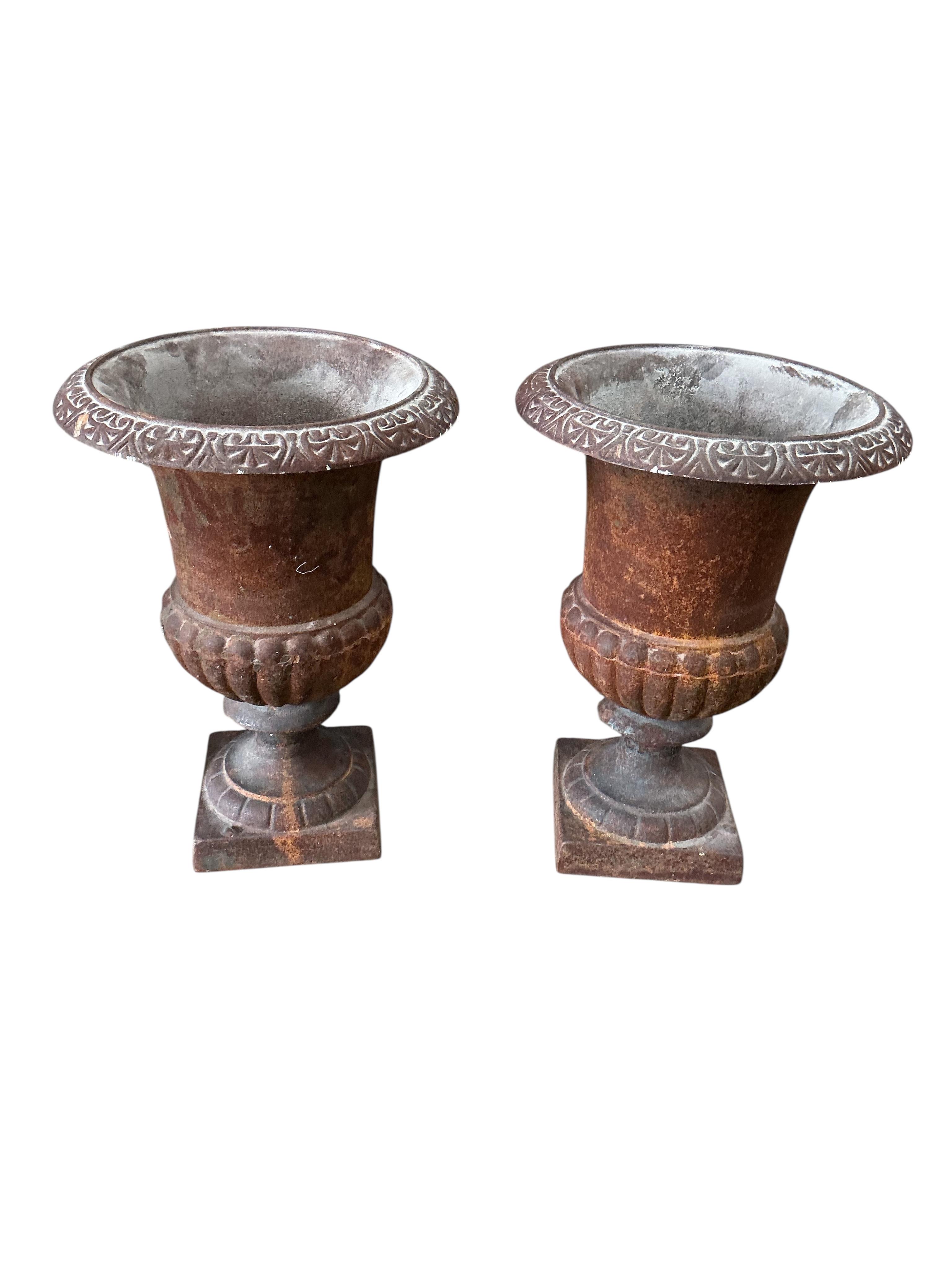 Two pairs of Victorian style cast iron campana urns, larger diameter 30cm, height 41cm, Provenance: The late Kenneth Turner (1936-2025), celebrity florist, designer and perfume retailer, he received the Royal Warrant fro